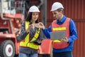 Engineers team managing cargo operations, Engineer with laptop and foreman worker checking containers box at shipping yard Royalty Free Stock Photo