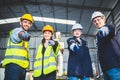 Engineers team mechanic standing in steel factory workshop. Industry robot programming software for automated manufacturing