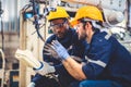 Engineers team mechanic using computer controller Robotic arm for welding steel in steel factory workshop. Industry robot