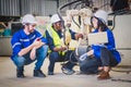 Engineers team mechanic using computer controller Robotic arm for welding steel in steel factory workshop. Industry robot