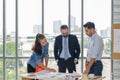 Engineers team meeting for architectural project. architects discussing blueprint with construction manager in office worker Royalty Free Stock Photo