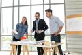 Engineers team meeting for architectural project. architects discussing blueprint with construction manager in office worker Royalty Free Stock Photo