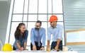 Engineers team meeting for architectural project. architects discussing blueprint with construction manager in office worker