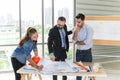 Engineers team meeting for architectural project. architects discussing blueprint with construction manager in office worker Royalty Free Stock Photo