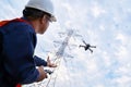 An engineers or technician are launching drones to inspect the power station for a planned work by generating electricity from a