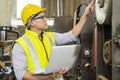 Engineers and technicians are carrying laptops in an industrial factory. Technicians are customizing the operation of industrial