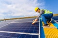 Engineers use a laptop computer to examine the solar panels at a power plant installed with solar panels using solar energy