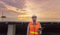Engineers use a tablet to work on roof inspection and maintenance in a solar power plant, which leads to green energy innovation