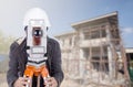 Engineers use tacheometer or theodolite with building construction site Royalty Free Stock Photo