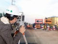 Engineers use tacheometer or theodolite with construction road w Royalty Free Stock Photo