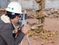 Engineers use tacheometer or theodolite with construction site Royalty Free Stock Photo