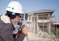 Engineers use tacheometer or theodolite with house construction Royalty Free Stock Photo