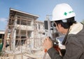 Engineers use tacheometer or theodolite with house construction Royalty Free Stock Photo