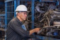 Engineers using tablet in the factory. A skilled mechanic inspecting auto parts in a factory