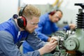 engineers working with factiry machinery wearing earmuffs Royalty Free Stock Photo