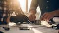 Engineers working on mechanical parts with blueprints on a table Royalty Free Stock Photo
