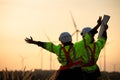 Engineers working on wind farms for renewable energy are in charge of massive wind turbine maintenance. Stand and watch the sunset