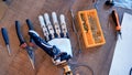 Engineers workplace with real cyborg humanlike hand. 4K.