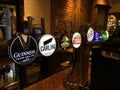 England - Draught beer taps in a traditional pub in London.