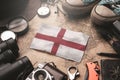 England Flag Between Traveler`s Accessories on Old Vintage Map. Tourist Destination Concept Royalty Free Stock Photo