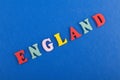 ENGLAND word on blue background composed from colorful abc alphabet block wooden letters, copy space for ad text