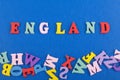 ENGLAND word on blue background composed from colorful abc alphabet block wooden letters, copy space for ad text. Learning english