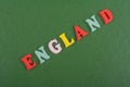 ENGLAND word on green background composed from colorful abc alphabet block wooden letters, copy space for ad text. Learning