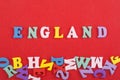 ENGLAND word on red background composed from colorful abc alphabet block wooden letters, copy space for ad text. Learning english Royalty Free Stock Photo