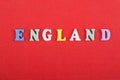 ENGLAND word on red background composed from colorful abc alphabet block wooden letters, copy space for ad text. Learning english