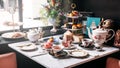 English afternoon tea set including hot tea, pastry, scones, sandwiches and mini pies on marble top table Royalty Free Stock Photo