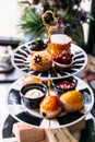 English afternoon tea set including hot tea, pastry, scones, sandwiches and mini pies on marble top table Royalty Free Stock Photo