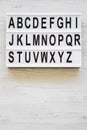 English alphabet on modern board over white wooden surface, top view. Letters from A to Z. Back to school concept. From above, Royalty Free Stock Photo