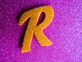 An English alphabet R pink background shiney