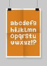 English alphabet. Twice a folded orange poster with clamps.