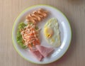 English breakfast consist of fried egg, bacon salad.