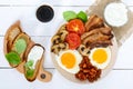 English breakfast: eggs, bacon, beans in tomato sauce, mushrooms, tomatoes, toast with cream cheese Royalty Free Stock Photo