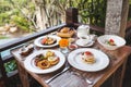 English breakfast with eggs Benedict and strawberry pancakes on wooden table Royalty Free Stock Photo