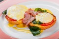 English breakfast- Fried bread toast with egg, spinach, tomatoes, mozzarella cheese and ham on plate Royalty Free Stock Photo