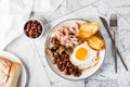 English breakfast with fried egg, bacon, beans, mushrooms and toast on a plate. Top view Royalty Free Stock Photo