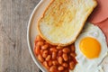 English breakfast: fried egg, bacon, beans and toast Royalty Free Stock Photo