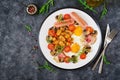 English breakfast - fried egg, beans, tomatoes, mushrooms, bacon and sausage. Royalty Free Stock Photo