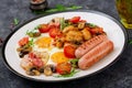 English breakfast - fried egg, beans, tomatoes, mushrooms, bacon and sausage. Royalty Free Stock Photo