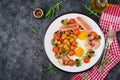 English breakfast - fried egg, beans, tomatoes, mushrooms, bacon and sausage Royalty Free Stock Photo