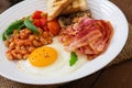 English breakfast - fried egg, beans, tomatoes, mushrooms, bacon Royalty Free Stock Photo