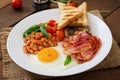 English breakfast - fried egg, beans, tomatoes, mushrooms, bacon Royalty Free Stock Photo