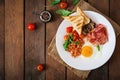 English breakfast - fried egg, beans, tomatoes, mushrooms, bacon and toast. Royalty Free Stock Photo