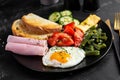 English breakfast fried egg, ham, green beans, tomatoes, cucumbers and toast Royalty Free Stock Photo