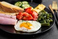 English breakfast fried egg, ham, green beans, tomatoes, cucumbers and toast Royalty Free Stock Photo
