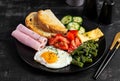 English breakfast. fried egg, ham, green beans, tomatoes, cucumbers and toast Royalty Free Stock Photo