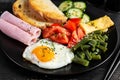 English breakfast. fried egg, ham, green beans, tomatoes, cucumbers and toast Royalty Free Stock Photo